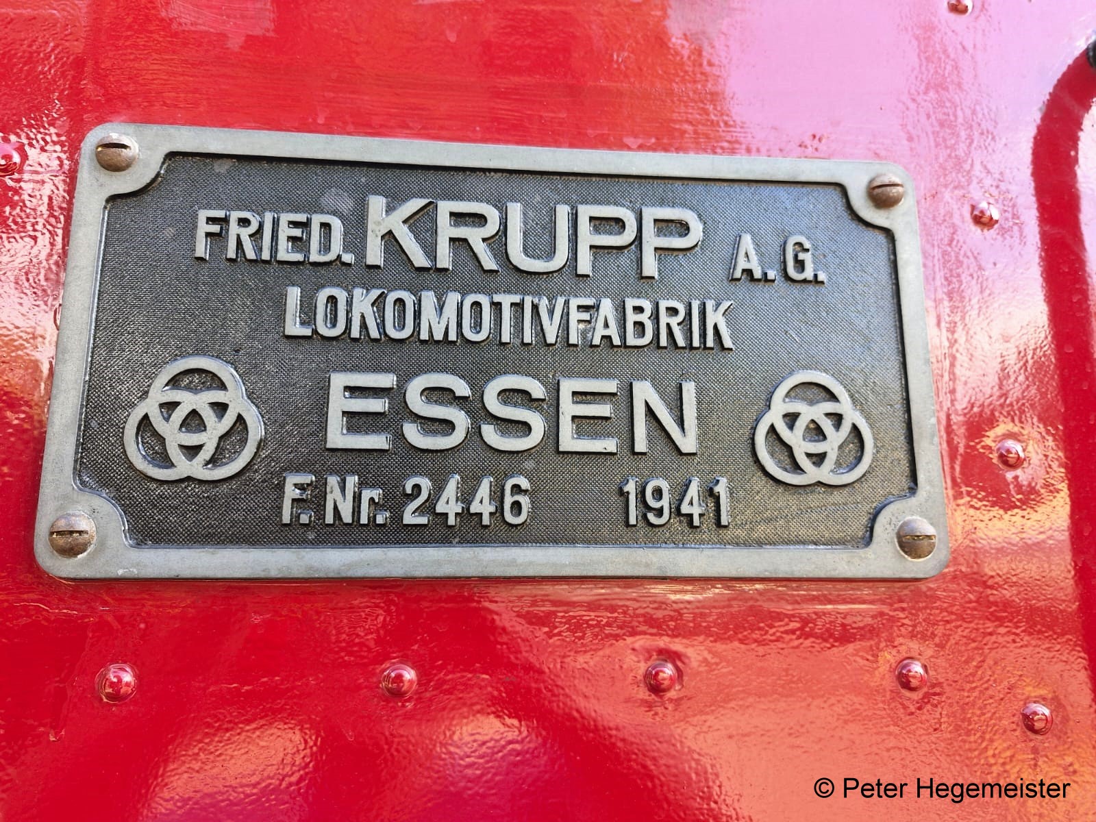 Fabrikschild der Diesellok R.K.11 - V1 des DEV vor dem Lokschuppen. Dieses Unikum ist ist die Nr. 11 der Rendsburger Kleinbahn. 1941 wurde diese Lok bei der Krupp AG Lokomotivfabrik gefertigt und mit der Nr. 2446 ausgeliefert. 