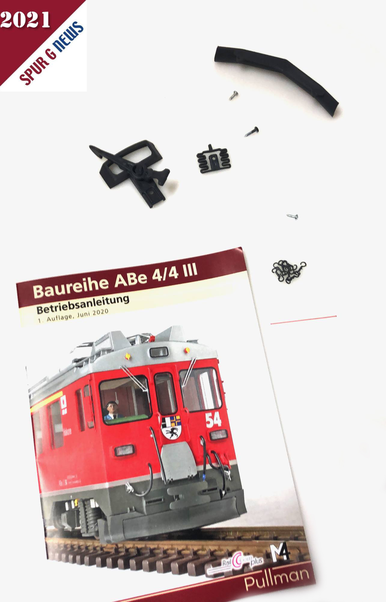 Beilage zum Triebwagen ABe 4/4 III: Bedienungsanleitung mit Zubehrteilen wie Kupplung mit Schrauben, Schienenrumer und kleinen Haken. 