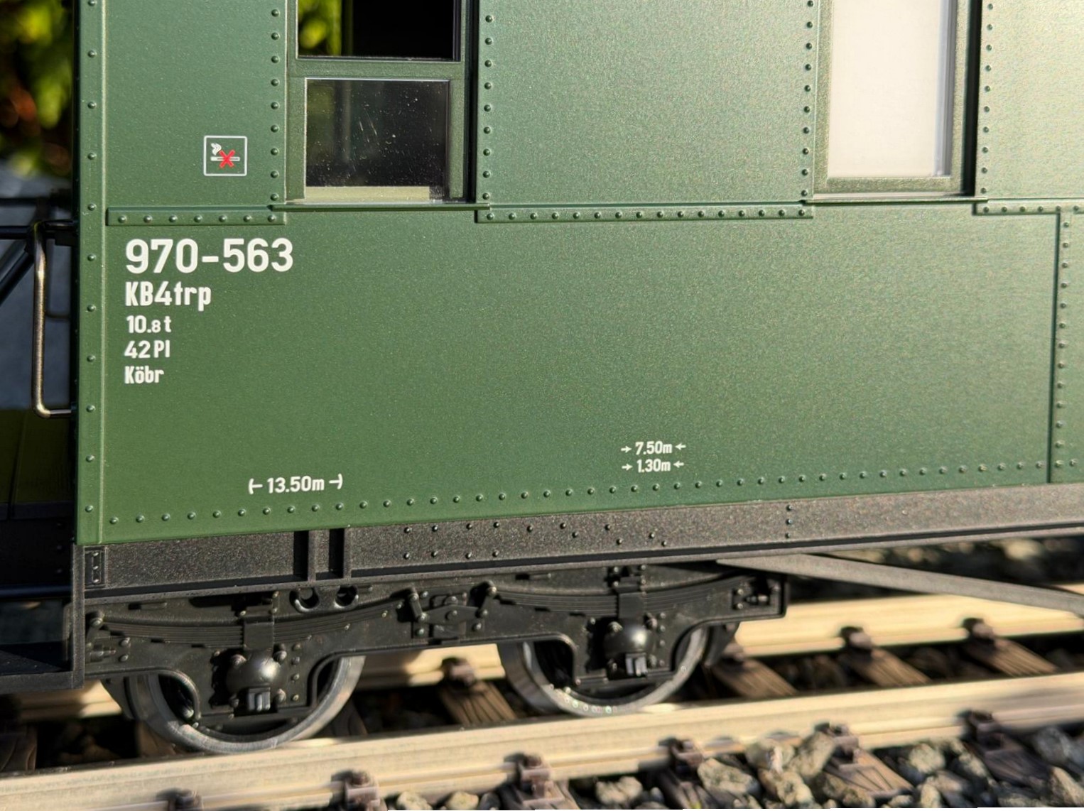 Detailansicht des LGB Art. Nr. 36371 - Personenwagen der DR - Bauart KD - Wagennummer 970-563. Sauber gedruckte Beschriftung an der Wagenseite. Nichtraucherpiktogramm, Wagennummer 970-563. Bauart KB4trp. 10,8 Tonnen mit 42 Pl�tzen. K�br = K�rtingbremse. L�nge �ber Puffer 13,50 Meter im Original. 